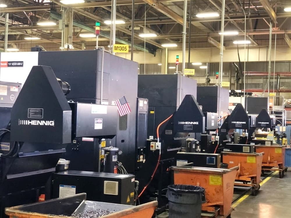 Hennig chip conveyors installed beside machine tools